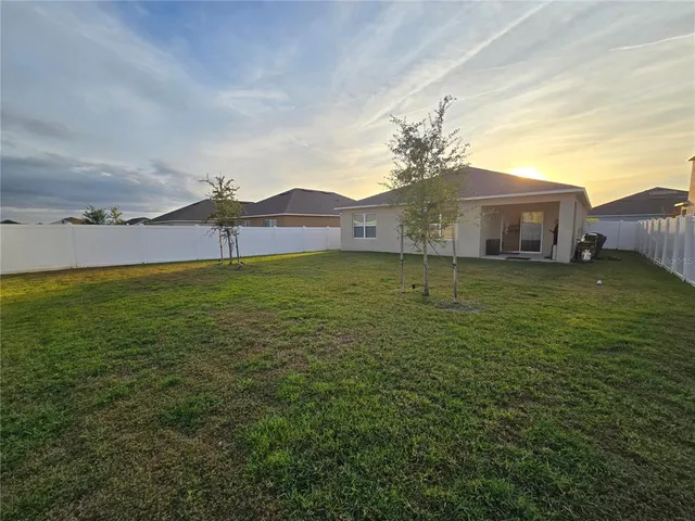 a view of yard with patio