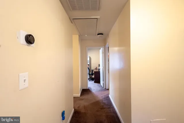 a view of a hallway with a dining room