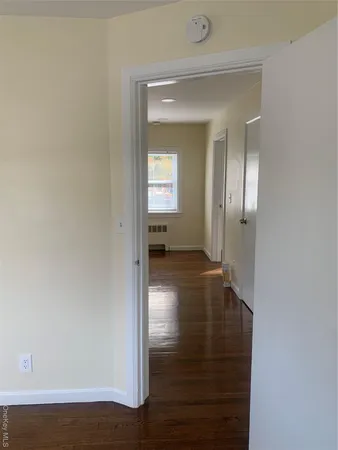 a view of a room with wooden floor and a staircase