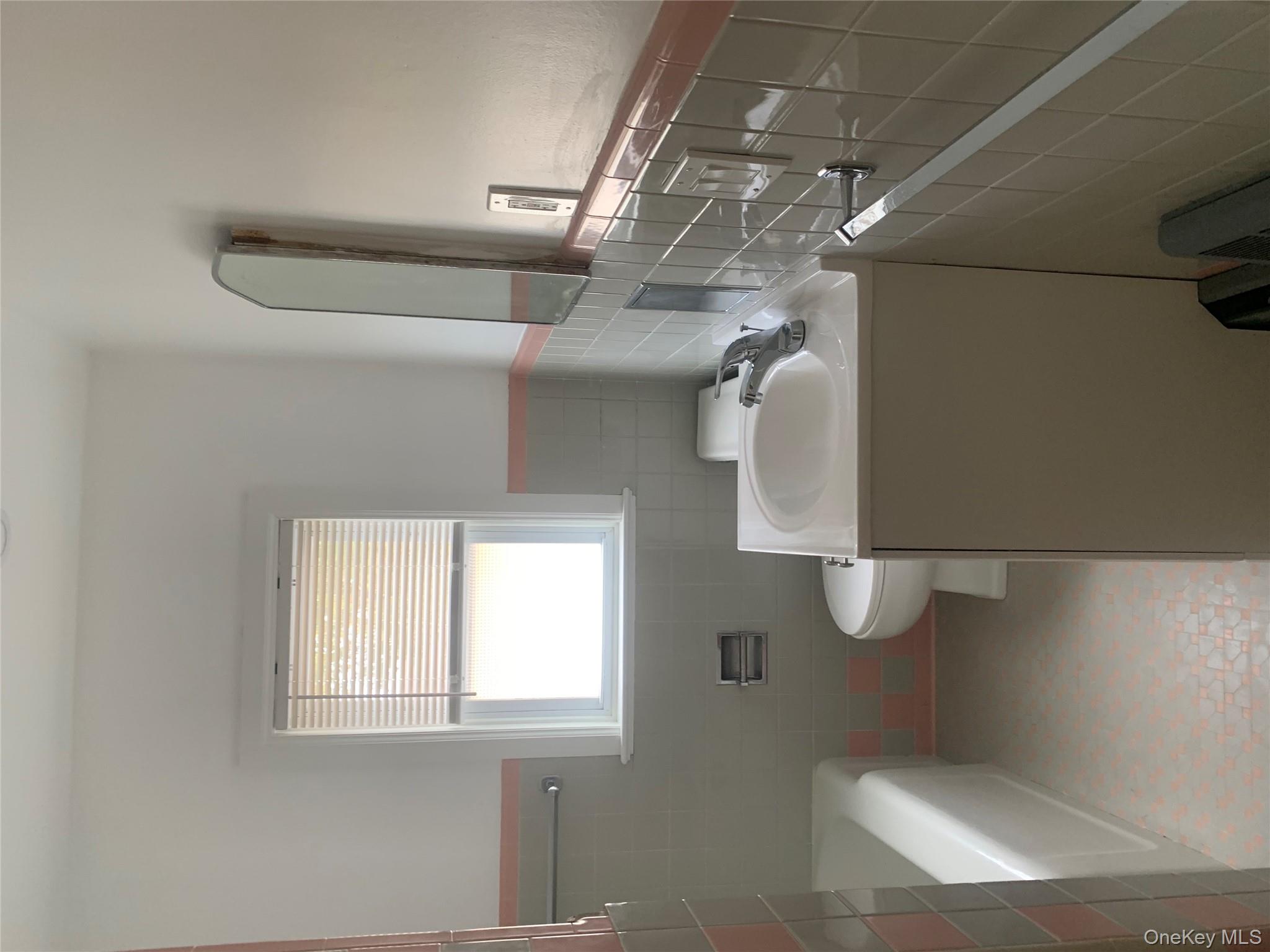 711 North Division Street Peekskill, NY 10566 - Photo 18 of 21 a bathroom with a toilet sink and mirror