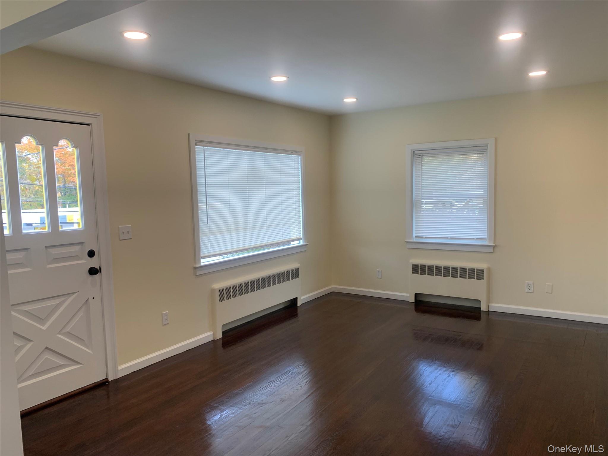 711 North Division Street Peekskill, NY 10566 - Photo 2 of 21 an empty room with wooden floor and windows