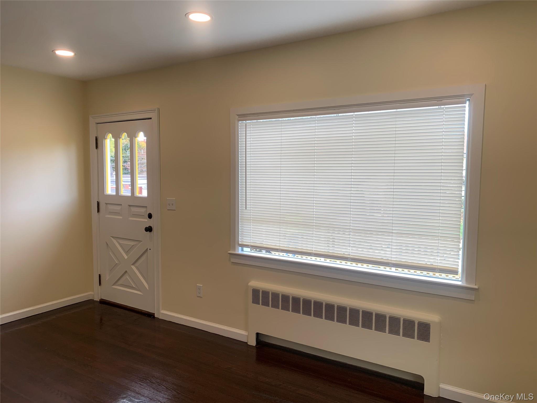 711 North Division Street Peekskill, NY 10566 - Photo 5 of 21 a view of an empty room with wooden floor and a window