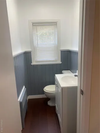 a bathroom with a sink a toilet and window