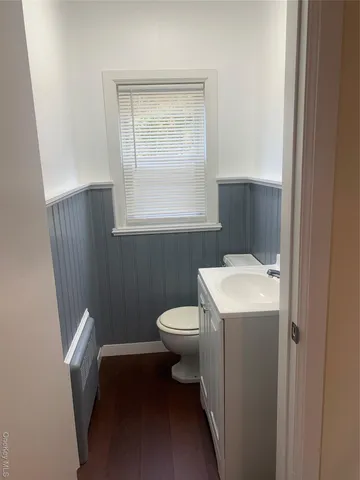 a bathroom with a sink a toilet and window