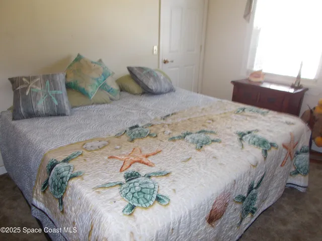 a bedroom with a bed with wooden floor