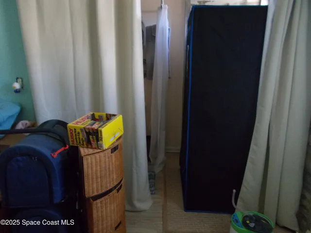 a living room with furniture a flat screen tv and a window
