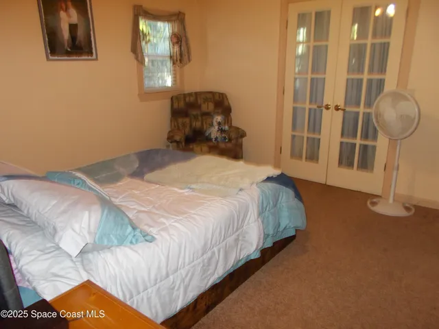 a bedroom with bed and window