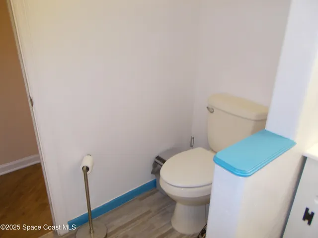 a bed sitting in a bedroom next to a window and dresser