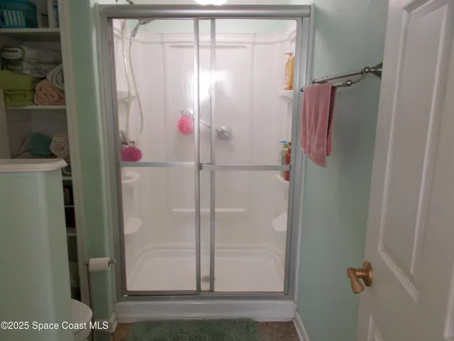 a bathroom with a glass shower door