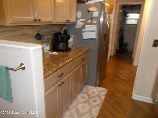a kitchen with granite countertop a sink stainless steel appliances and cabinets