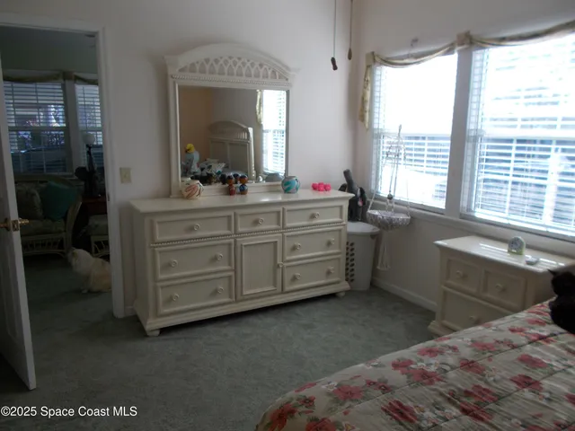 a room with a bed and a large window