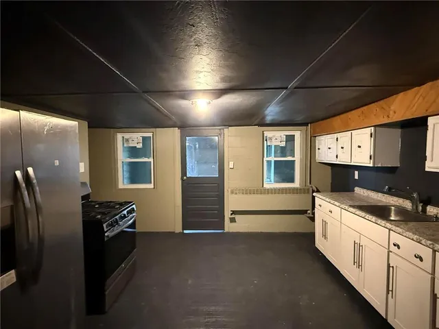 a large kitchen with a stove and a refrigerator