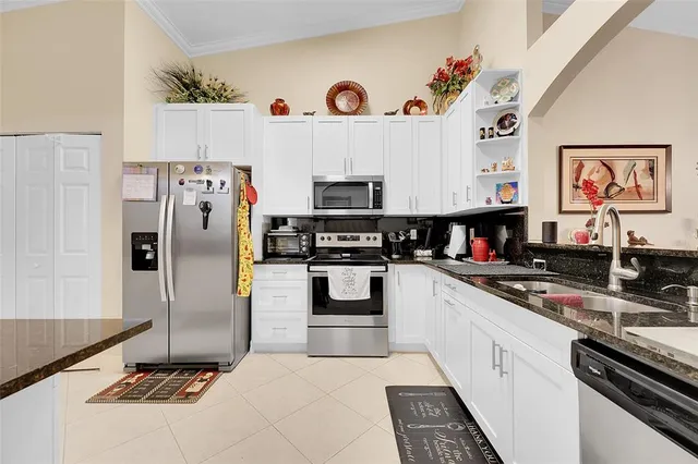 a kitchen with stainless steel appliances a refrigerator a stove and a sink