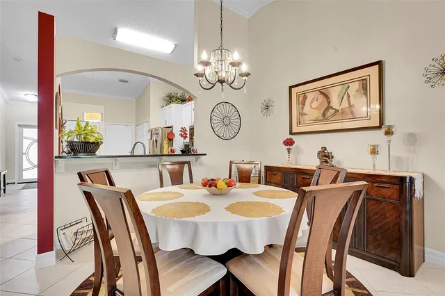 a view of a dining room with furniture a chandelier and wooden floor