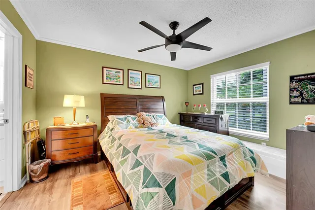 a bedroom with a bed and a large window