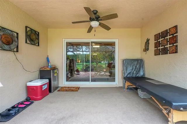 a living room with furniture gym equipment and a large window