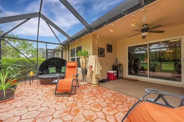 a view of a patio with a table and chairs under an umbrella
