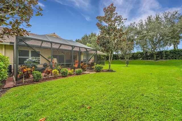a view of a chair and table in backyard of the house