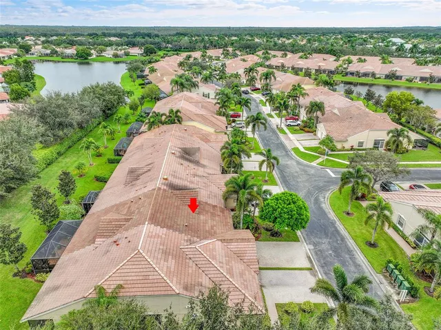 an aerial view of residential houses with outdoor space and river