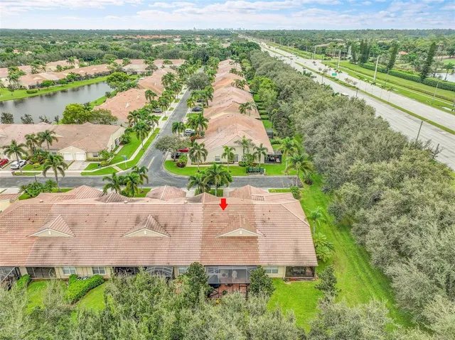 an aerial view of residential houses with outdoor space and street view