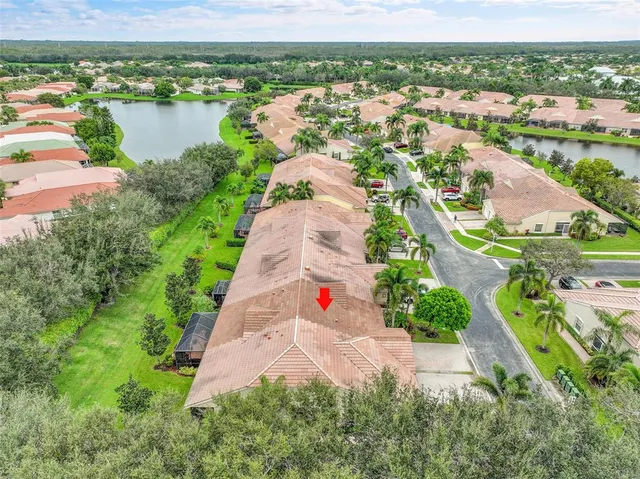 an aerial view of residential houses with outdoor space and river