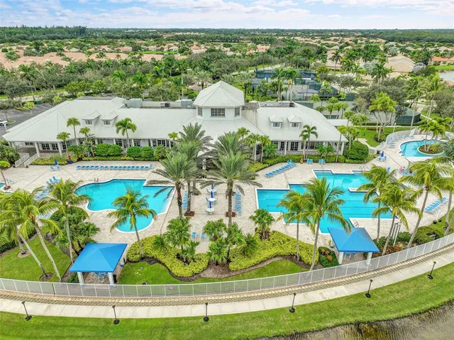 an aerial view of residential houses with outdoor space and swimming pool