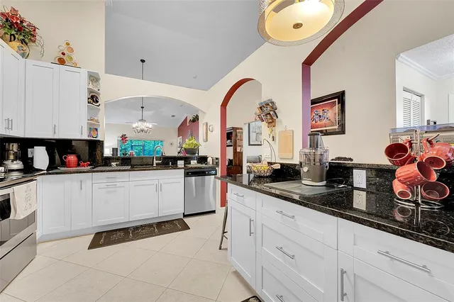 a kitchen with stainless steel appliances granite countertop a sink and cabinets