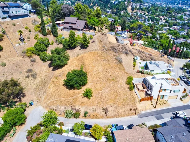 an aerial view of a house with a yard and lake view