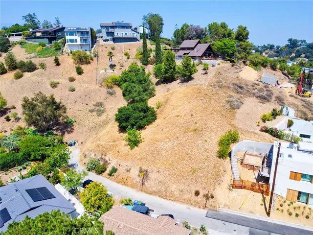an aerial view of a house with a yard and trees