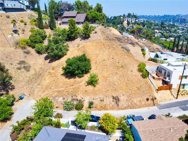 an aerial view of a house with a yard and lake view