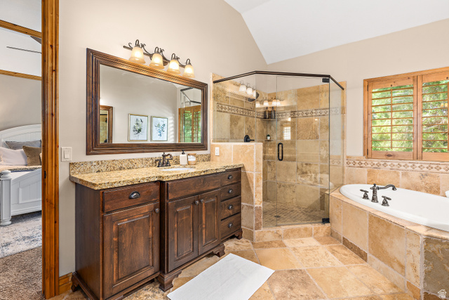 552 East Johns Way Sandy, UT 84070 - Photo 25 of 67 Double vanity with granite countertop, glass-enclosed shower, built-in soaking tub, and tile flooring