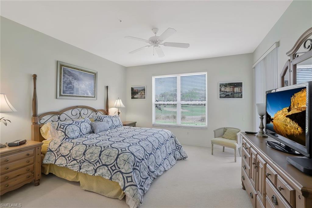8457 Radcliffe Terrace, Unit 102 Naples, FL 34120 - Photo 14 of 33 Bedroom featuring light colored carpet and ceiling fan