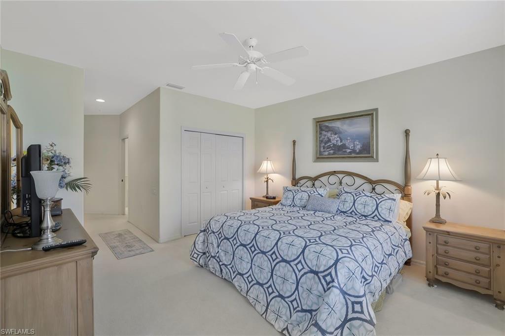 8457 Radcliffe Terrace, Unit 102 Naples, FL 34120 - Photo 15 of 33 Bedroom with light carpet, a closet, ceiling fan, and recessed lighting