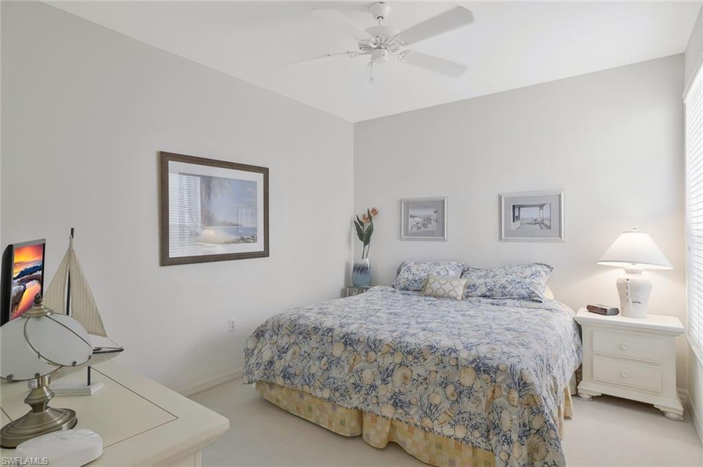 8457 Radcliffe Terrace, Unit 102 Naples, FL 34120 - Photo 18 of 33 Bedroom with light colored carpet and ceiling fan