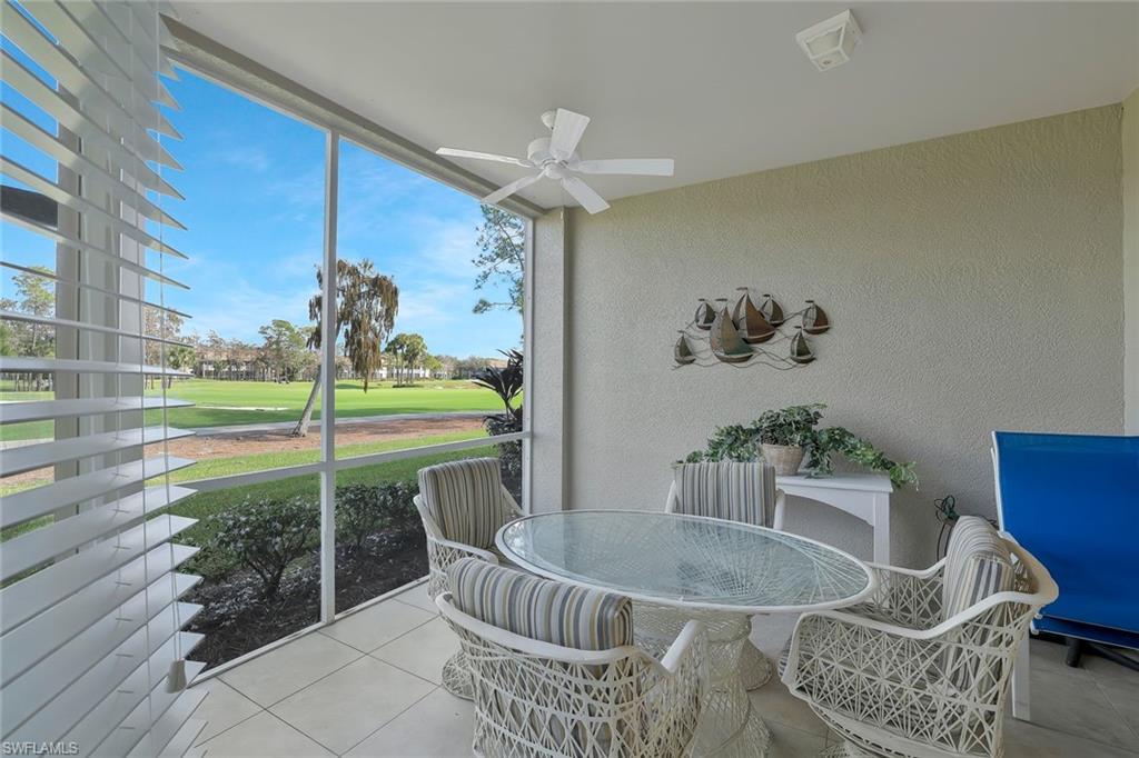 8457 Radcliffe Terrace, Unit 102 Naples, FL 34120 - Photo 20 of 33 Sunroom featuring outdoor dining area, golf course view, and ceiling fan