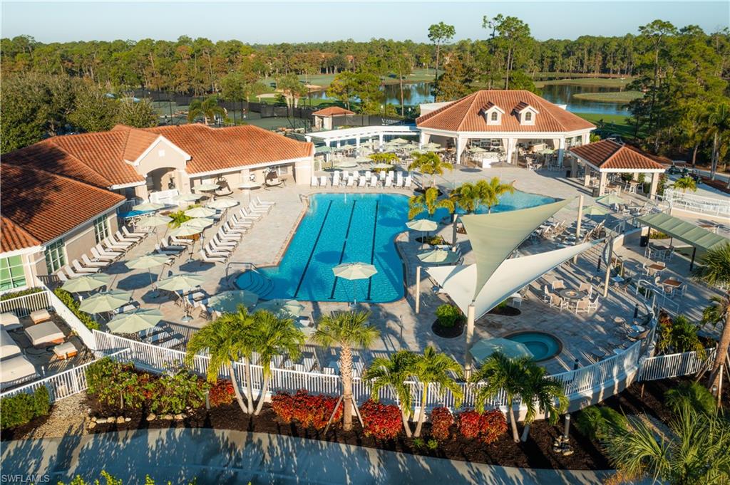 8457 Radcliffe Terrace, Unit 102 Naples, FL 34120 - Photo 28 of 33 Community pool featuring a patio area and view of scattered trees