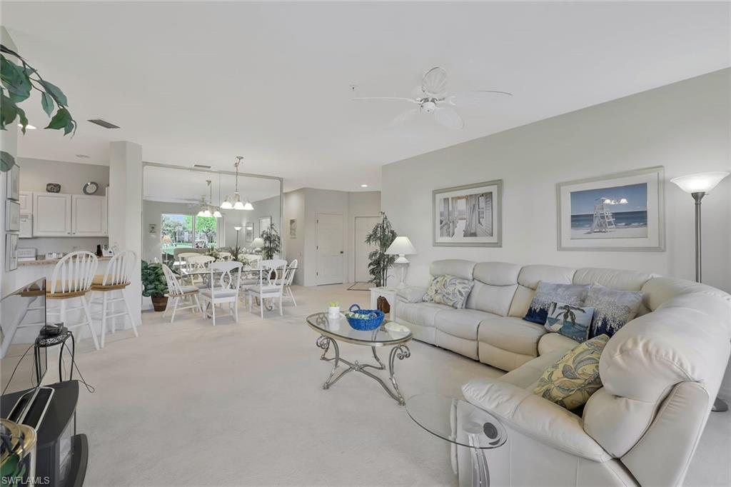 8457 Radcliffe Terrace, Unit 102 Naples, FL 34120 - Photo 7 of 33 Living area with ceiling fan and light carpet