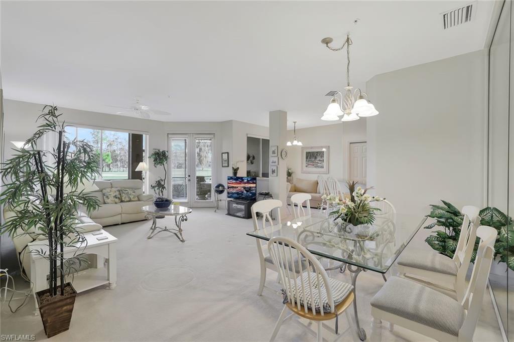 8457 Radcliffe Terrace, Unit 102 Naples, FL 34120 - Photo 9 of 33 Dining room featuring a ceiling fan and hanging lights