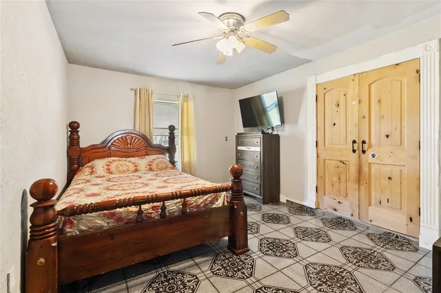 a bedroom with a bed and wooden floor