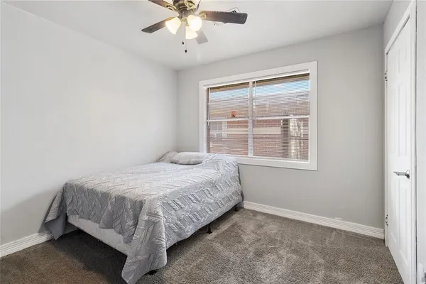 a bed sitting in a bedroom next to a window
