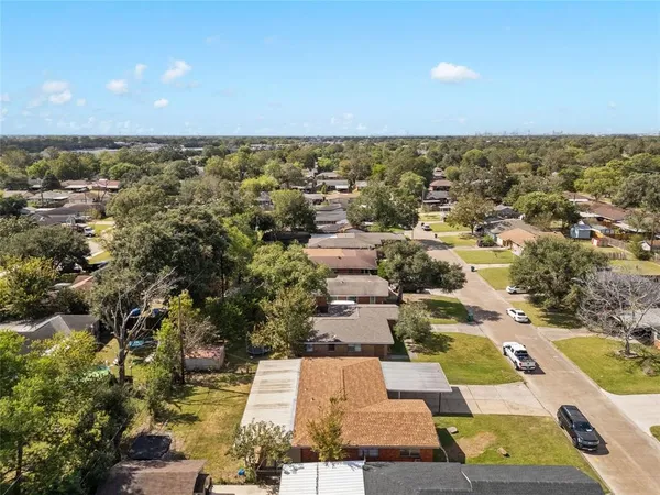 an aerial view of residential houses with yard