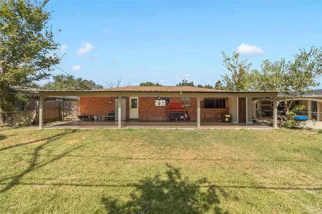 a view of a house with a yard and sitting area