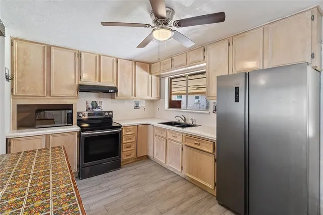 a kitchen with stainless steel appliances granite countertop a stove cabinets and refrigerator