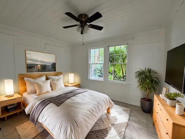 a bedroom with a large bed and a tv