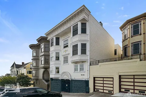 a front view of a residential apartment building with a yard