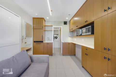a kitchen with stainless steel appliances granite countertop a refrigerator and a stove