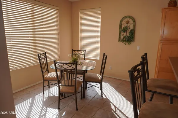 a living room with furniture kitchen and a large window