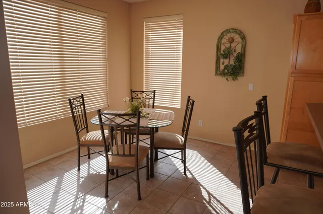 a living room with furniture kitchen and a large window