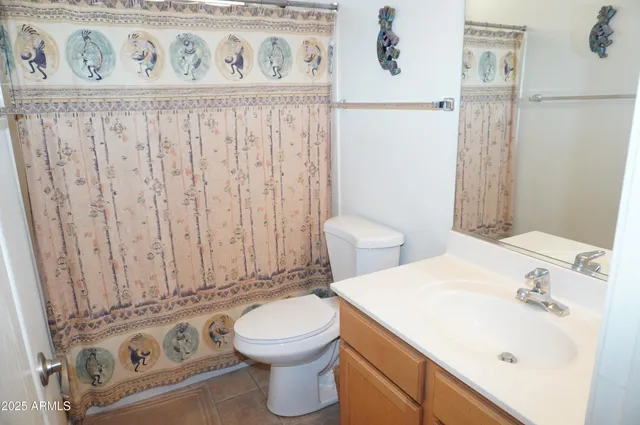 a large bed sitting in a bedroom next to a window