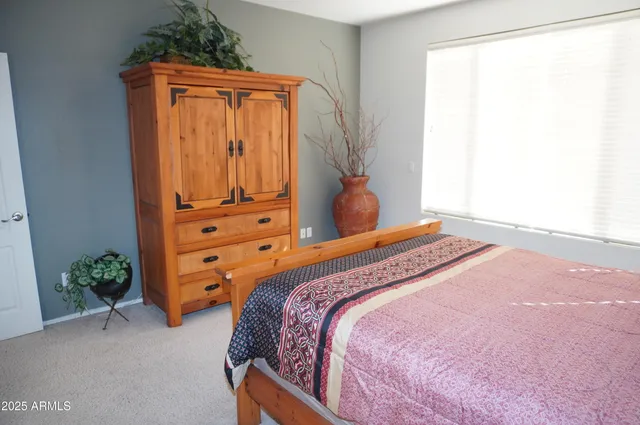 a spacious bathroom with a double vanity sink a mirror and a bathtub
